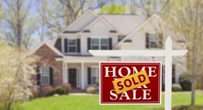 a home sold sign in front of a house.